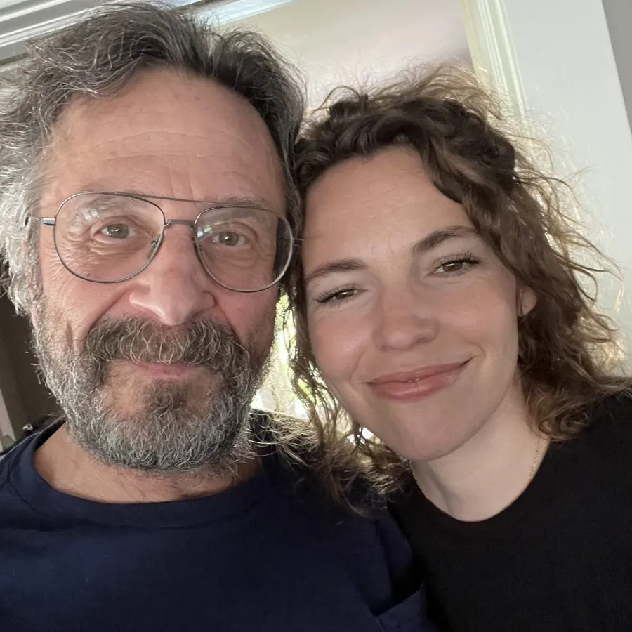 Beth taking a selfie with a bearded man in glasses